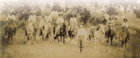 <strong> How does the top photograph of Texas cowboys in the 1880s refute the image of cowboy life that Charles Russell portrayed in his 1897 painting The Herd Quitters?</strong> A) Cowboy work was unexciting and filled with drudgery. B) Cowboys came from many racial and ethnic backgrounds. C) Cowboys herded cattle in various geographical environments, not just the open plains. D) Cowboy attire was often more flamboyant than what Russell's painting depicts.