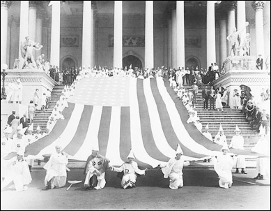 <strong> Based on this souvenir postcard from a lynching in Marion, Indiana, and the photograph of the 1925 Ku Klux Klan march in Washington, D.C., what conclusion can be reached about both lynch mobs and the Ku Klux Klan during the 1920s?</strong> A) They revived their activities after being suppressed during Reconstruction. B) Their targets included not only African Americans, but also Jews, Catholics, immigrants and feminists. C) They were unashamed of their actions and unafraid to reveal their identities. D) Although they were usually prosecuted for their crimes, juries rarely found them guilty.