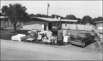<strong> These two 1955 photographs of a suburban middle-class family called What They Have vs. What They Own featured in Life magazine demonstrate that American families .</strong> A) moved to suburbs in great numbers B) relied heavily on credit to maintain affluent lifestyles C) were made up of a white-collar working father and a stay-at-home mother D) benefitted greatly from New Deal and Fair Deal programs