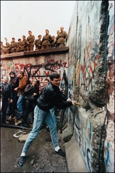 <strong> How do these images of the man with the hammer in Berlin and Tank Man in Beijing's Tiananmen Square tell two different stories about Communism in Eastern Europe and China in the late 1980s?</strong> A) Eastern European nations suffered severe retaliations for demonstrating against Communism, while Chinese officials responded with economic and political reforms. B) Soviet troops invaded protesting Eastern European nations, while the Chinese were more responsive to human rights. C) The man with the hammer was arrested and probably executed for his actions, while Tank Man became known for his defense of human rights. D) Communism in most of Eastern Europe fell through peaceful demonstrations, while demonstrators in China were unsuccessful in their attempts to bring about reform.
