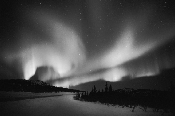 <strong>An aurora is produced when </strong> A) charged particles flow toward the magnetic poles and excite atmospheric gases. B) swamp gases rise from the Arctic tundra and react with the upper atmosphere. C) radiation in the Van Allen belts can be seen on a clear,cold night. D) lightning travels from cloud to cloud rather than cloud to ground.
