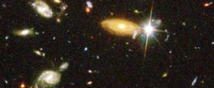 <strong>A frame of the HST deep field image of distant galaxies is shown.By means of optical and radio telescopes astronomers can see distant objects like these as they ... </strong> A) are right now. B) will be in the distant future. C) were in the distant past. D) All of the above. E) None of the above.