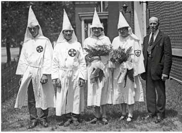 <strong>What does the image of the Ku Klux Klan wedding from 1925 (Document 21.2) reveal about the organization?  </strong> A) It remained a southern organization. B) It remained predominantly rural. C) It had given up on white supremacist terrorism. D) It had become a socially acceptable public organization. <div style=padding-top: 35px> 