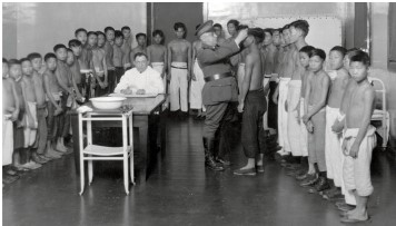 <strong>The image Angel Island Physical Exam shows a group of Chinese boys waiting to see the doctor while a military official inspects one of them. Viewed in the context of the history of Chinese immigration to the United States in the latter nineteenth century, which of the following conclusions can you draw from this image? </strong> A) Chinese immigrants were treated as individuals. B) Immigration officials cared for the health and well-being of Chinese immigrants. C) Immigration officials looked at Chinese as a threat to public health. D) Chinese immigrants were grateful for getting to see a doctor upon their arrival.