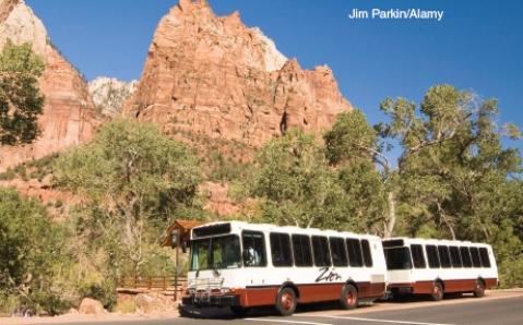 The two photographs below represent solutions to some of the threats faced by National Parks in the U.S. today. Describe the threat and explain how what is shown in the photo is a potential solution. A B