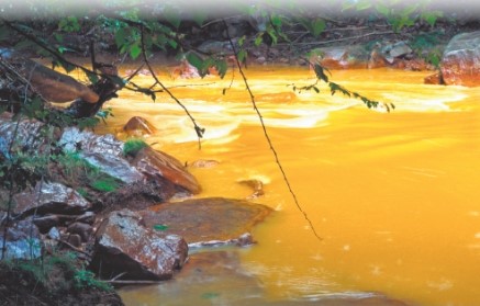The two photos below show two different ways that mining contaminates the environment. Compare and contrast the specific ways that mining affects the environment in each case. A B