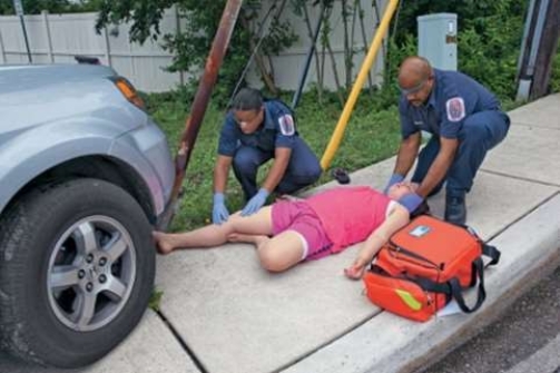 <strong>In this photo, the EMS personnel are involved in which phase of a typical EMS response? </strong> A) Dispatch/response B) Detection of the emergency C) Care during transport D) On-scene care