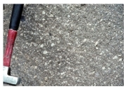 <strong>90)Which of the following photographs depicts an igneous rock where the magma cooled slowly at first and then had fast cooling?</strong> A) B) C) D)