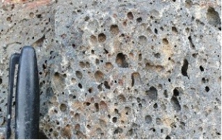 <strong>119)What type of rock is shown in this photograph from the Investigation? </strong> A)volcanic rocks, probably basalt B)granite C)metamorphic rocks D)sedimentary rocks