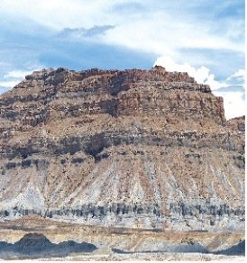 <strong>121)What type of rock likely composes the landscape shown in this photograph from the Investigation? </strong> A)volcanic rocks, probably basalt B)granite C)metamorphic rocks D)sedimentary rocks