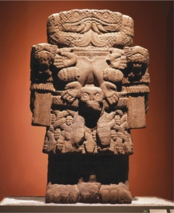 <strong> How does the Aztec sculpture of Coatlicue (figure 17.17) from the central pyramid complex of Tenochtitlán embody her formidable and intimidating nature?</strong> A) Snakes for blood, armor, and wood material B) Abstraction, clawed fingers, and Storm God imagery C) Human skulls, compact mass, and a beard D) Large size, compact mass, and imagery of violence