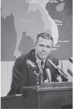 <strong> -Secretary of Defense Robert McNamara is shown here</strong> A) Giving a press conference on Vietnam B) Speaking at a university commencement C) Giving the president a personal briefing on Operation Rolling Thunder D) Promoting the Vietnam War among America's allies