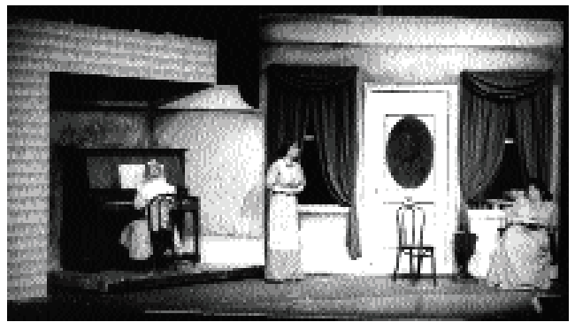 <strong>Who has compositional focus in this shot? </strong> A) The girl playing the piano B) The woman standing in the center C) The woman sitting at the right