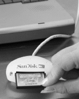 <strong> In the figure shown above, a memory card is being inserted into a ____.</strong> A)USB port B)docking station C)card reader D)FireWire port