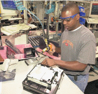 <strong> Figure 15-3 Typical jobs for workers in the ____ include service technician, computer repairperson (like the one in Figure 15-3), repair technician, and computer technician.</strong> A) computer equipment field B) computer software field C) computer service and repair field D) computer education and training field