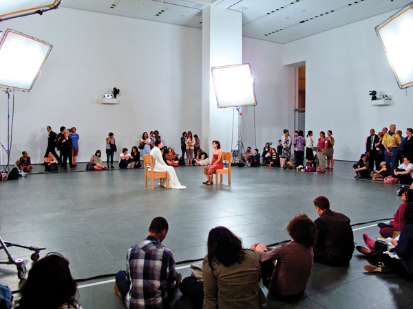 <strong> In Marina Abramovic's performance piece The Artist Is Present , which element, along with the artist's body, constitute the art piece?</strong> A)Improvised music B)Actions of the audience C)Video footage D)Backup dancers