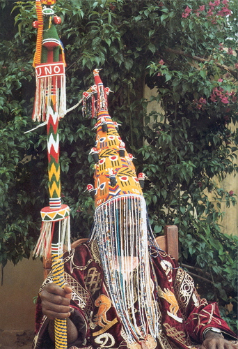 <strong> Which statement is true of the Yoruba Great Beaded Crown of the Orangun-Ila ?</strong> A)Scale is used to show the importance of the Yoruba leader. B)Status is conveyed both through materials and symbolic shapes used. C)The genre painting design emphasizes the wearer's connection with the people governed. D)The style is influenced by objects acquired from Portuguese traders.