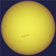 <strong>The figure shows the Sun and pairs of sunspots. One could say that there is really a 22-year sunspot cycle because  </strong> A) the time between sunspot number maxima is 22 years. B) the time between maxima of the same magnetic polarity of sunspot pairs is 22 years. C) it takes sunspots 22 years to move from the poles to the equator. D) at maximum there are 22 sunspots per year. <div style=padding-top: 35px> 